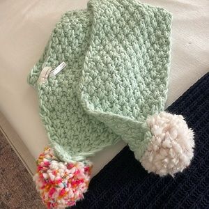 Long Anthropologie scarf with interchangeable pom poms